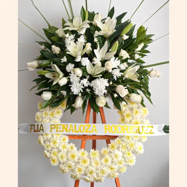 Elegante Corona Fúnebre con flores de condolencias; lirios, pompones y rosas blancas. Domicilio 100% gratis en todas las funerarias y salas de velación en Bogotá.